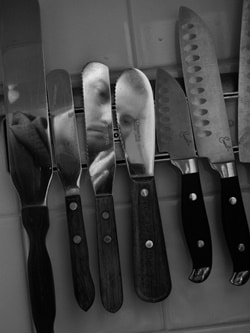 Black and white image of common cooking utensils.